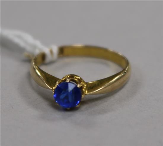 A 14ct gold ring set with a blue paste stone, size K